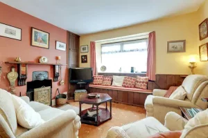 An image of the living space and television, fireplace and window in our Family holiday cottage in Scarborough, North Yorkshire.