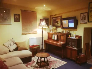 An image of the piano, television and living space in our family holiday cottage in Dalby Forest, North Yorkshire.