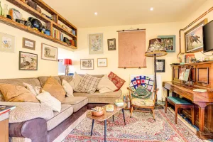 An image of the living area, sofa, piano and television, perfect for families to relax. Enjoy our beautiful family holiday cottage in North Yorkshire.