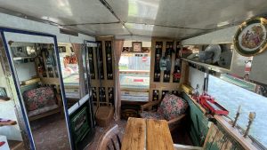 An interior image of the portmaster glamping wagon based in Dalby forest, North Yorkshire. A view from the living space into the one double bedroom.