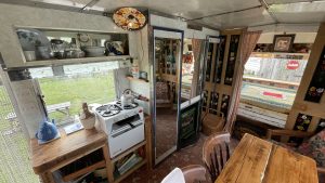 An interior image of the portmaster glamping wagon based in Dalby forest, North Yorkshire. Dining and cooking area.