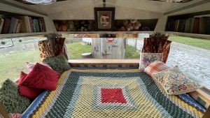 An interior image of the portmaster glamping wagon based in Dalby forest, North Yorkshire. Bed and sleeping space.