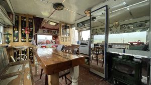 An interior image of the portmaster glamping wagon based in Dalby forest, North Yorkshire. Kitchen and living space.